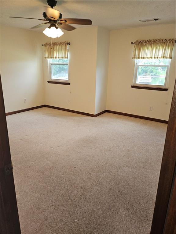 2752 Inverloch Cir, Duluth, GA 30096 - unfurnished room with light carpet, ceiling fan, and baseboards