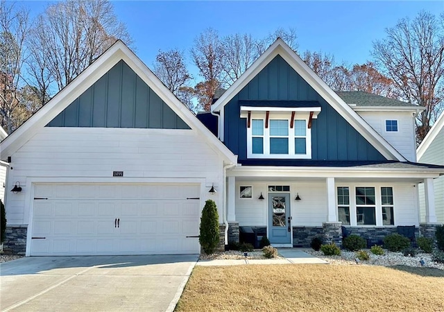 craftsman inspired home featuring covered porch, a front yard, and a garage