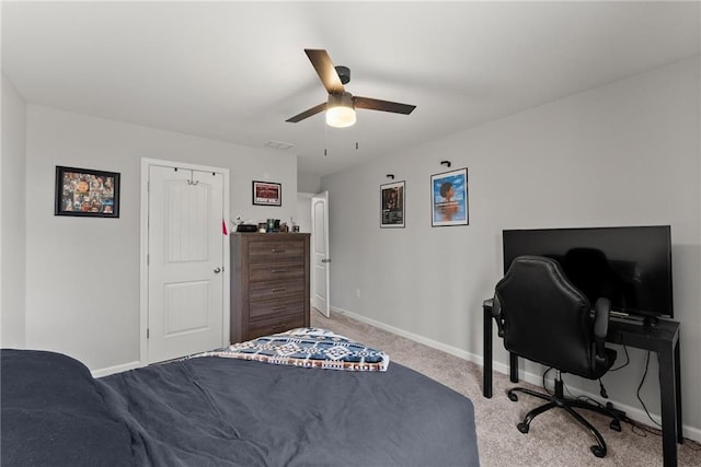 bedroom with light carpet, ceiling fan, visible vents, and baseboards