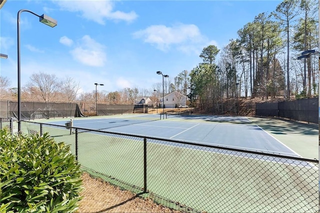 view of sport court featuring fence