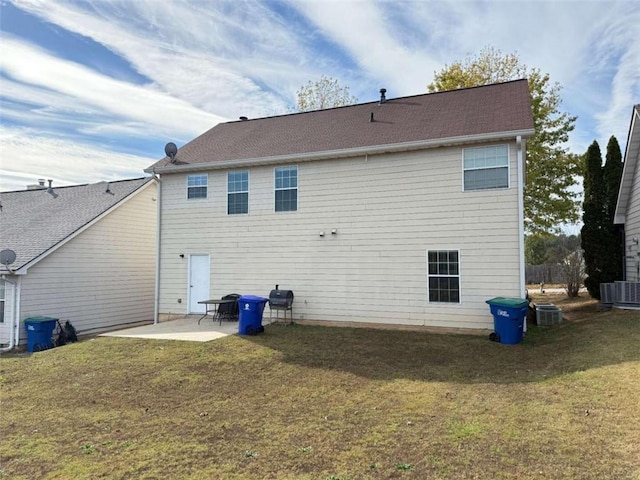 rear view of property with a patio, cooling unit, and a lawn