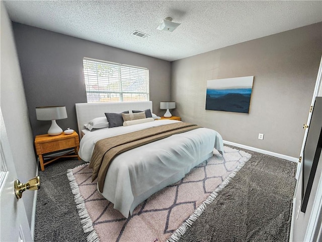 carpeted bedroom featuring a textured ceiling