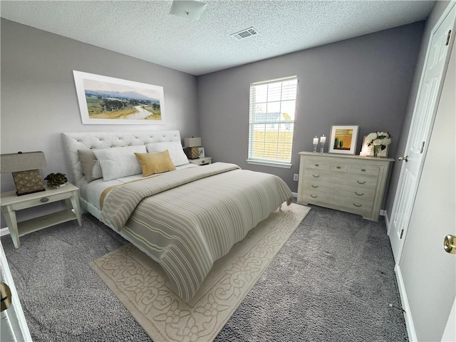 carpeted bedroom featuring a textured ceiling