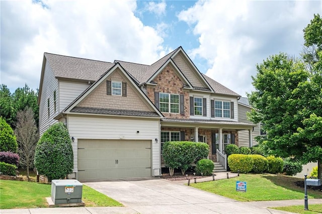 558 Olympic Way, Acworth, GA 30102 - craftsman-style home featuring driveway, a front yard, a porch, stone siding, and a shingled roof
