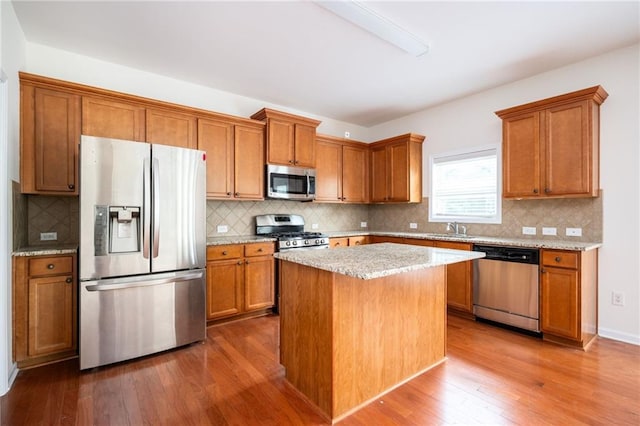 558 Olympic Way, Acworth, GA 30102 - kitchen with appliances with stainless steel finishes, brown cabinetry, dark wood-style floors, and decorative backsplash