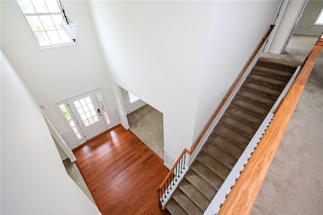 558 Olympic Way, Acworth, GA 30102 - foyer entrance featuring stairs, plenty of natural light, a high ceiling, and wood finished floors