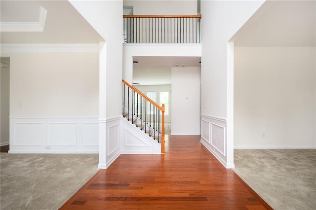 558 Olympic Way, Acworth, GA 30102 - foyer with carpet flooring, stairway, a decorative wall, crown molding, and wood finished floors