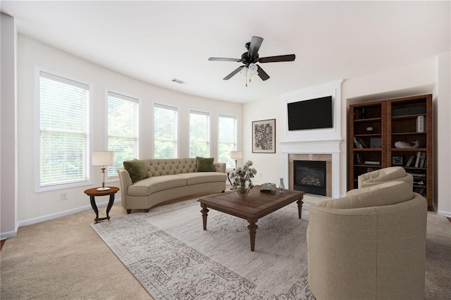 558 Olympic Way, Acworth, GA 30102 - living room with a tiled fireplace, ceiling fan, and light colored carpet