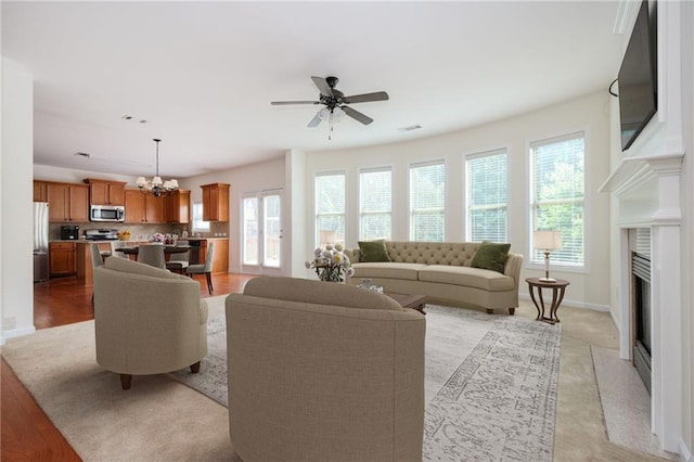 558 Olympic Way, Acworth, GA 30102 - living area with a ceiling fan, a chandelier, and a fireplace
