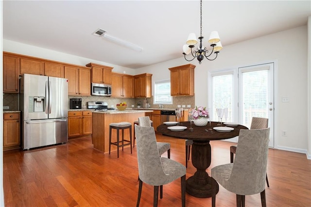 558 Olympic Way, Acworth, GA 30102 - dining area featuring a chandelier and dark wood finished floors