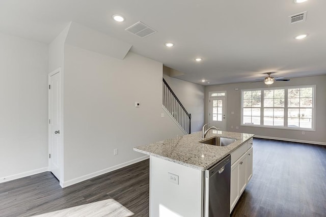 kitchen with white cabinetry, an island with sink, dishwasher, light stone counters, and sink