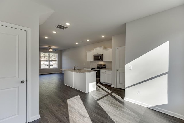 kitchen featuring white cabinetry, a center island with sink, ceiling fan, stainless steel appliances, and light stone countertops