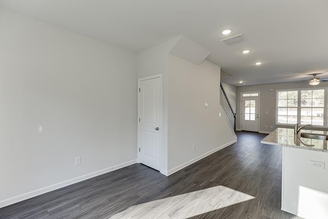 spare room with ceiling fan, dark wood-type flooring, and sink