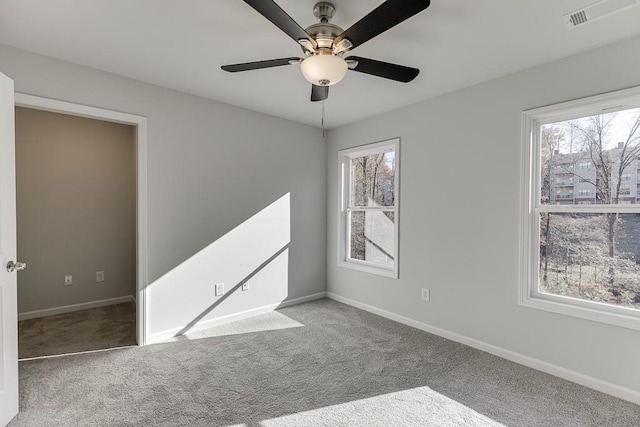 carpeted empty room featuring ceiling fan