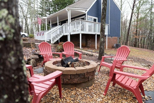 rear view of property featuring an outdoor fire pit