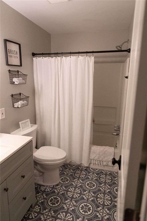 full bathroom with tile patterned floors, vanity, toilet, and shower / bath combination with curtain