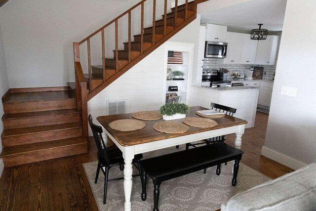 dining room featuring hardwood / wood-style flooring and a notable chandelier