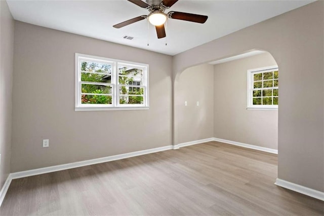 empty room with wood-type flooring and ceiling fan