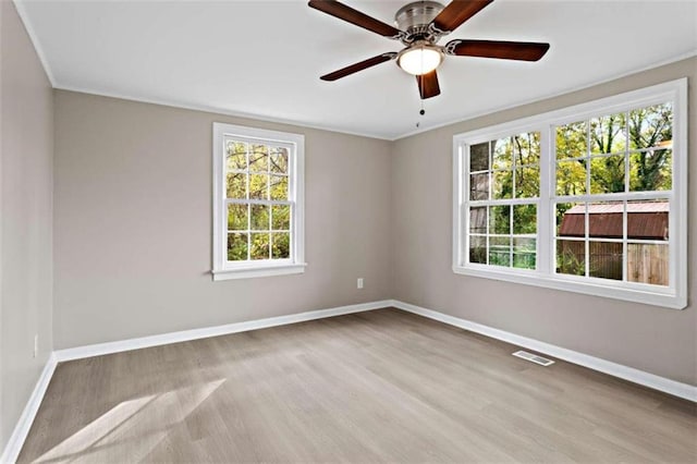 spare room featuring light hardwood / wood-style flooring and ceiling fan