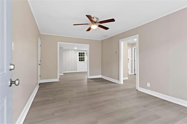 spare room with ceiling fan, ornamental molding, and light hardwood / wood-style flooring