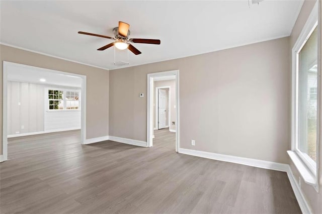 empty room featuring ceiling fan and light hardwood / wood-style floors