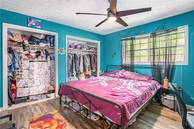 2087 Chestnut Way, Lithia Springs, GA 30122 - bedroom featuring a textured ceiling, wood finished floors, and a ceiling fan