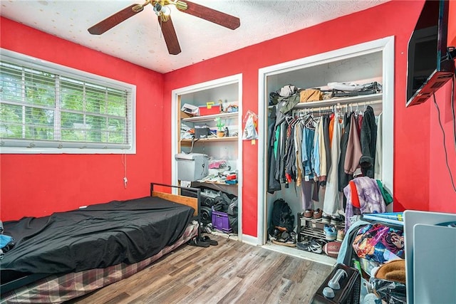 2087 Chestnut Way, Lithia Springs, GA 30122 - bedroom with a closet, wood finished floors, and ceiling fan