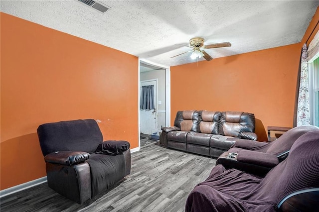 2087 Chestnut Way, Lithia Springs, GA 30122 - living area with wood finished floors, baseboards, ceiling fan, and a textured ceiling