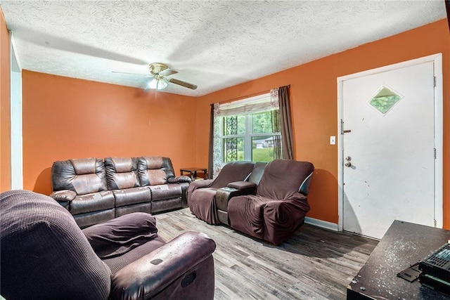 2087 Chestnut Way, Lithia Springs, GA 30122 - living room with wood finished floors, a ceiling fan, baseboards, and a textured ceiling