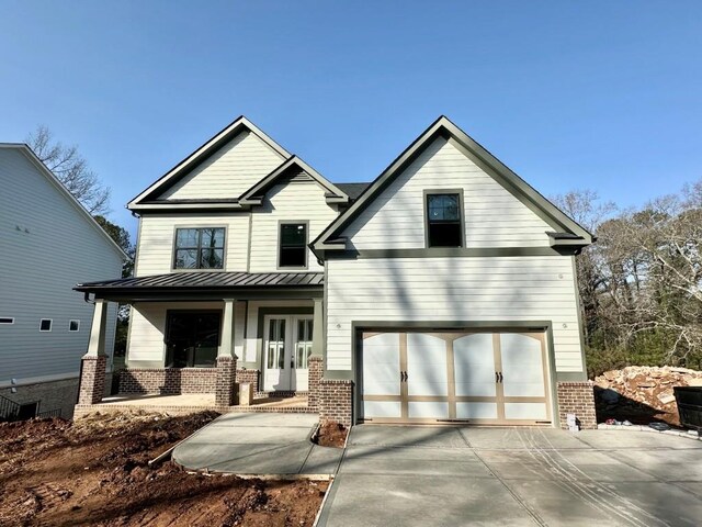 view of front of house with a porch and a garage