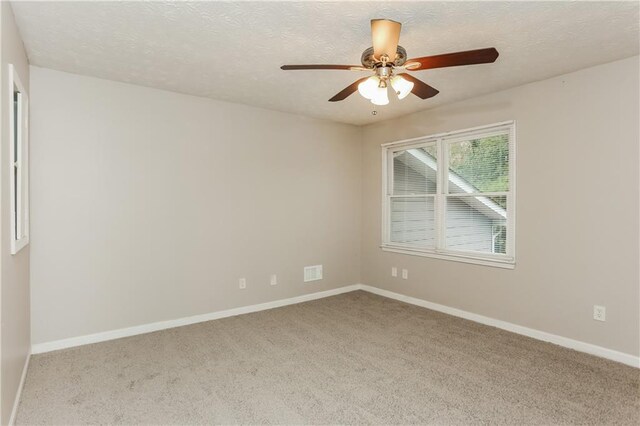 4893 Autumn Cir, Stone Mountain, GA 30088 - spare room with a textured ceiling, carpet floors, visible vents, and baseboards