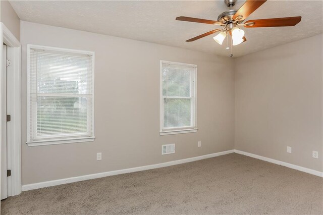 4893 Autumn Cir, Stone Mountain, GA 30088 - empty room with baseboards, carpet, visible vents, and a textured ceiling