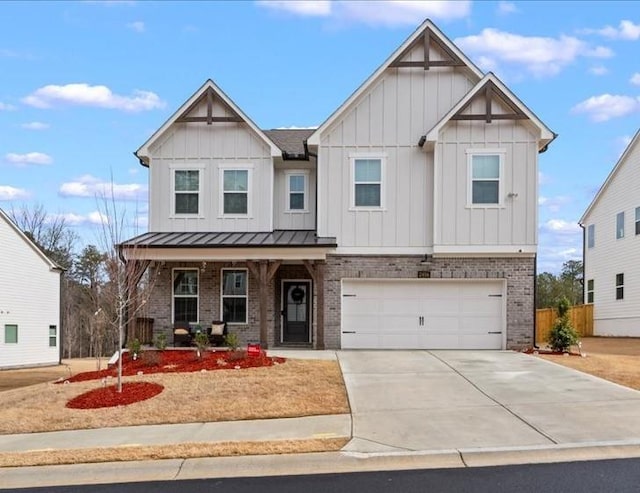 view of front of property featuring covered porch, brick siding, driveway, board and batten siding, and a standing seam roof