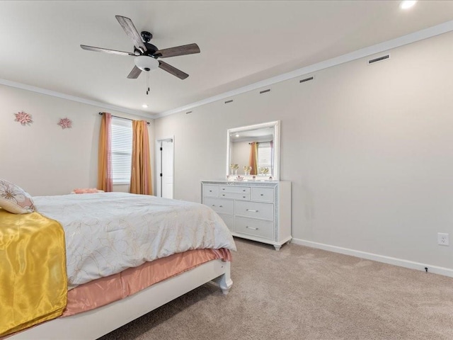 bedroom with crown molding, light colored carpet, visible vents, ceiling fan, and baseboards