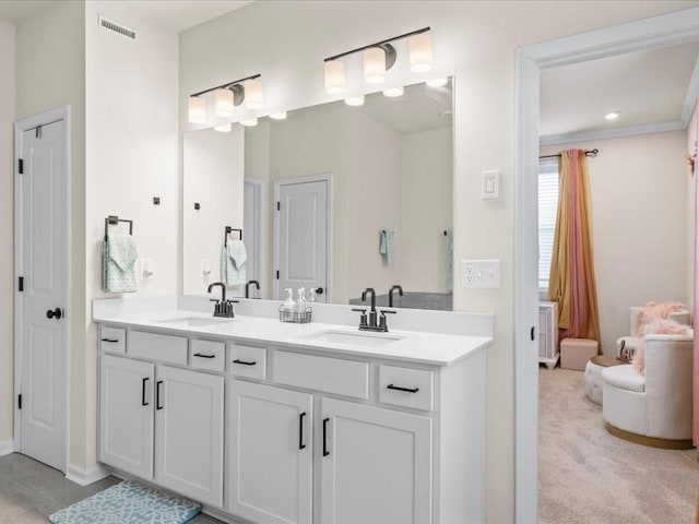 full bath with double vanity, visible vents, and a sink