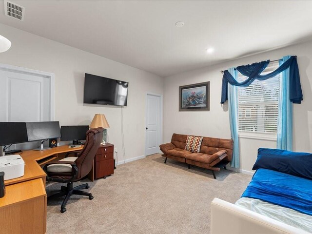 washroom with light carpet, laundry area, baseboards, and separate washer and dryer