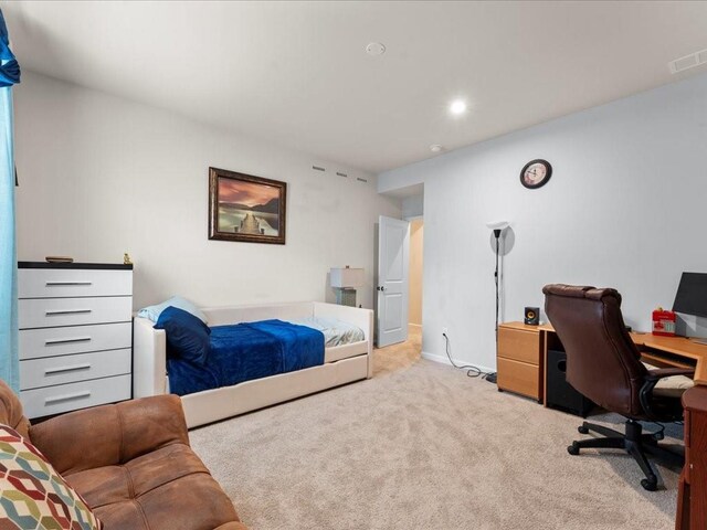 home office featuring light colored carpet, visible vents, and baseboards