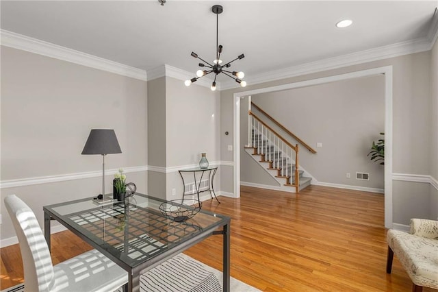 interior space with stairway, light wood-style flooring, crown molding, and visible vents