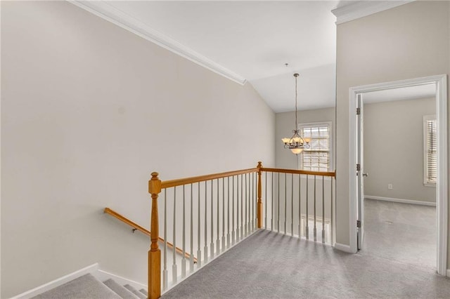hallway with an upstairs landing, carpet, baseboards, a chandelier, and vaulted ceiling