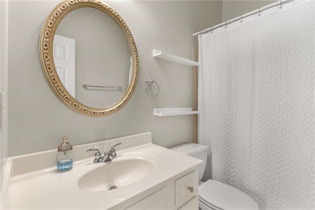 bathroom featuring vanity and toilet