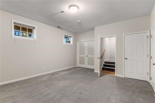 unfurnished bedroom featuring visible vents, baseboards, and carpet
