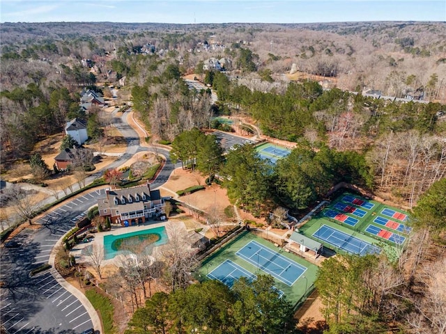 birds eye view of property featuring a view of trees
