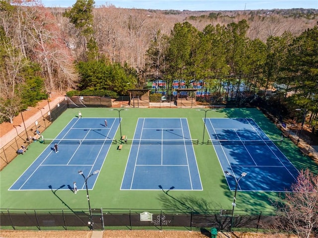 view of tennis court with fence