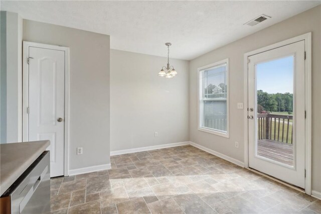 unfurnished dining area featuring a notable chandelier, visible vents, stone finish floor, and baseboards