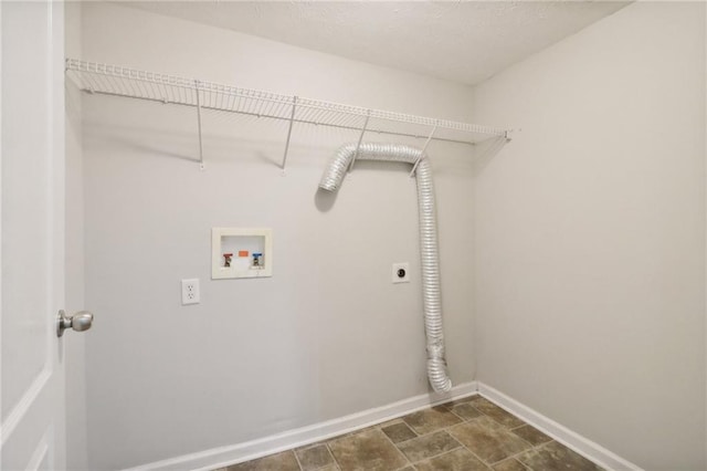 laundry area with hookup for a washing machine, baseboards, laundry area, electric dryer hookup, and stone finish floor