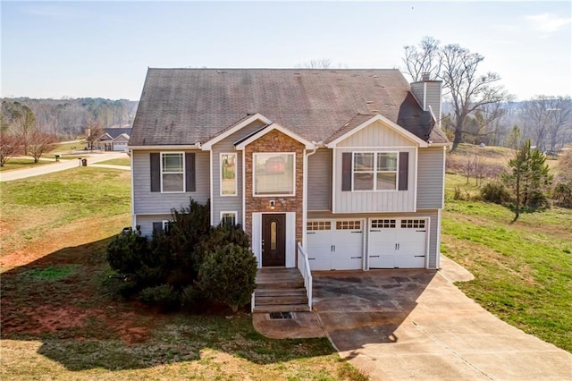 view of front of property with a front yard, driveway, an attached garage, a chimney, and board and batten siding