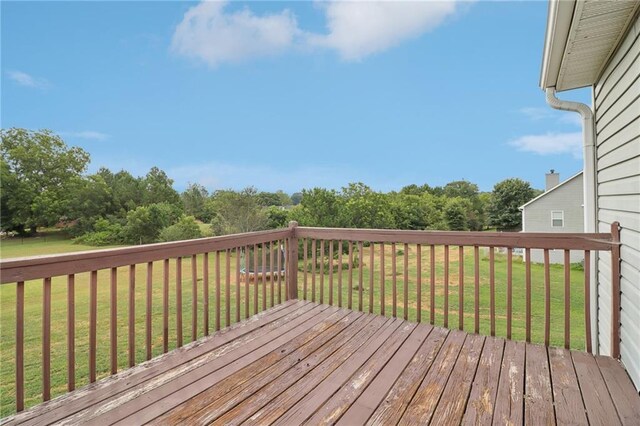 wooden terrace featuring a lawn