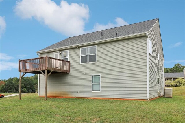 back of house featuring a yard and a wooden deck