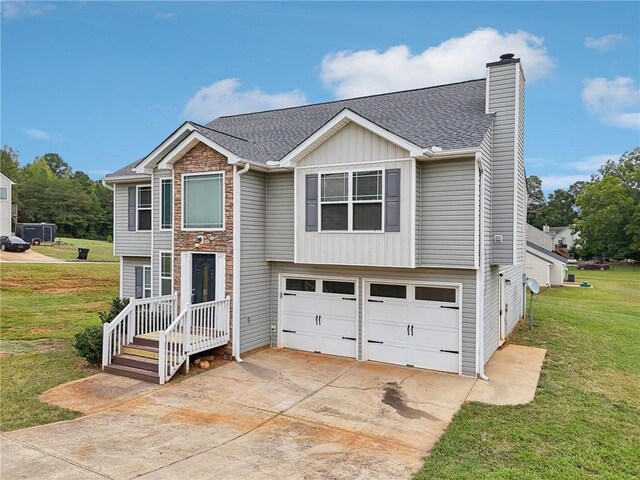view of front of house featuring a front yard, a chimney, concrete driveway, a garage, and board and batten siding