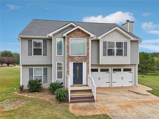 view of front of house featuring board and batten siding, a front lawn, concrete driveway, a chimney, and a garage